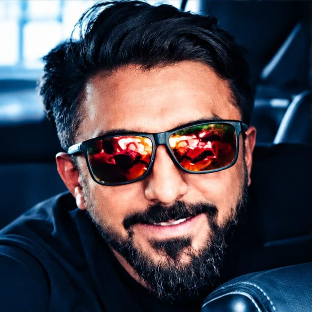 Abhi, smiling, wearing sunglasses
