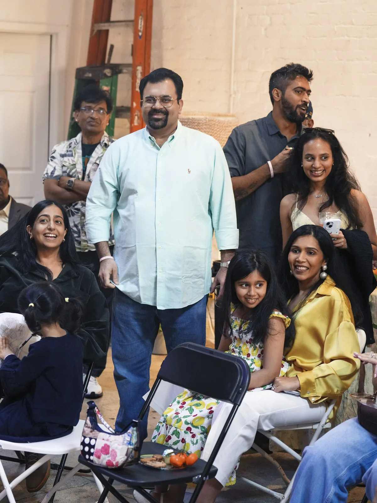 A community group of different generations gathered together indoors